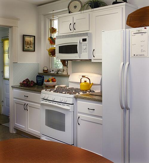 frosty white kitchen cabinets with rosemary corian countertop