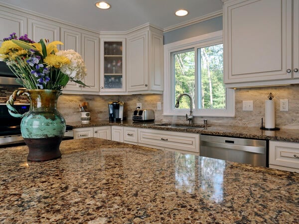 Cambria Canterbury countertop and Antique White cabinets