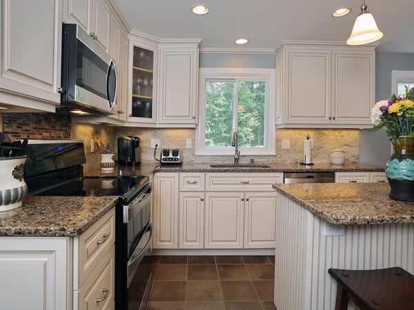 Cambria Canterbury countertops and Antique White cabinets