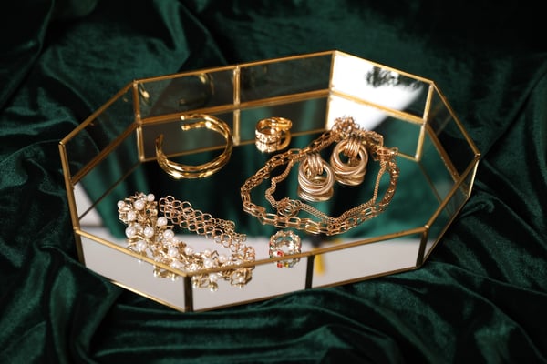 ENV- beautiful-gold-jewelry-on-dark-green-cloth-closeu-2026-01-11-10-59-14-utc