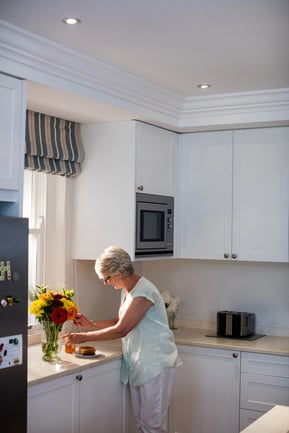 senior woman in traditional white kitchen