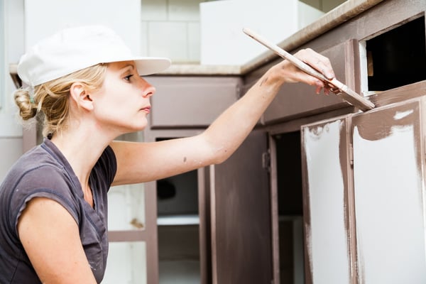 Envato-blog image-woman painting cabinets- 06.17.25