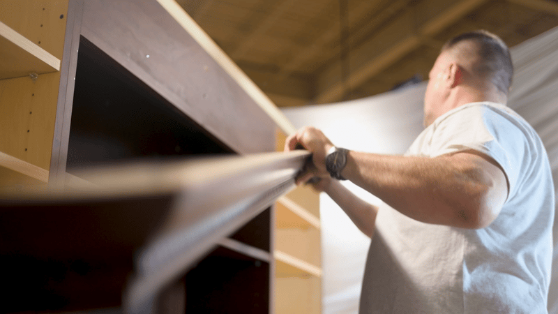 Installer removes frames of cabinets as the first step of cabinet refacing