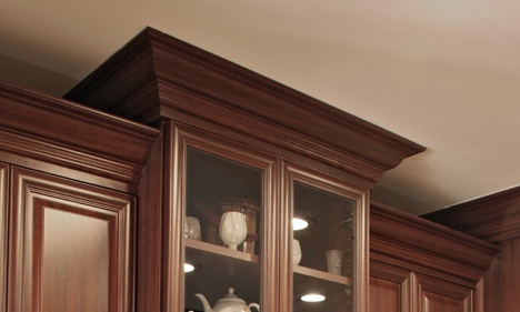 Dark Cherry Wood Glass-Front Kitchen Cabinet with Crown Molding