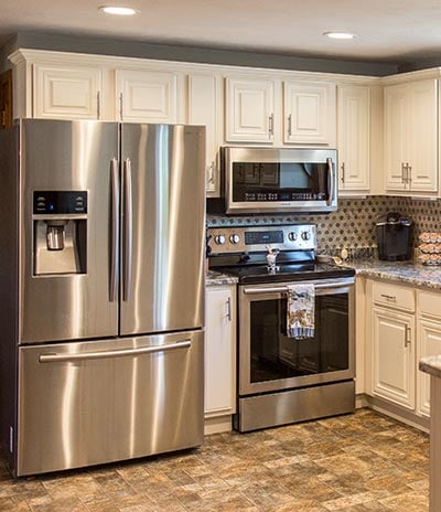 white kitchen with stainless steel appliances