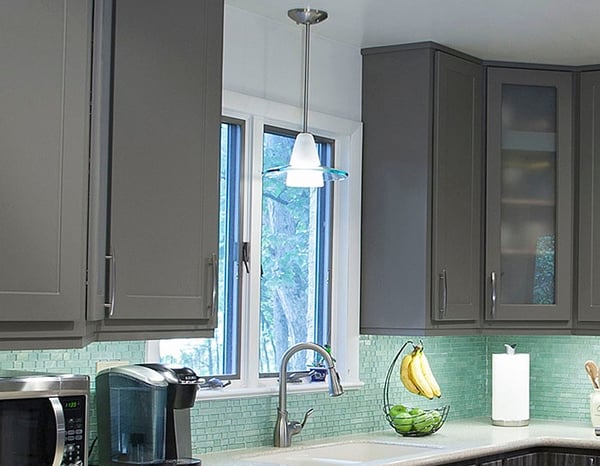 Gray Kitchen with Green Backsplash and Pendant Light