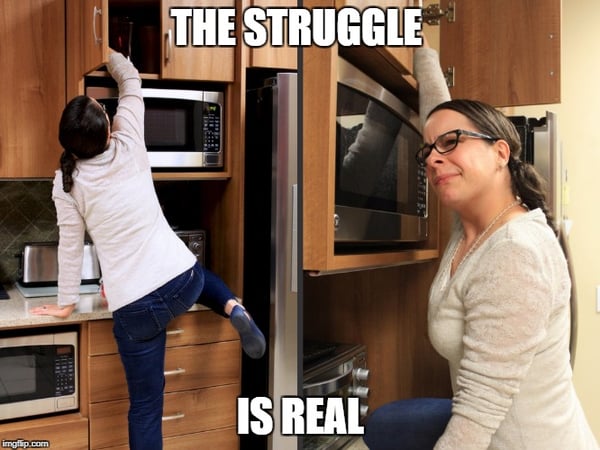 Woman Struggling to Reach Items in a High Kitchen Cabinet