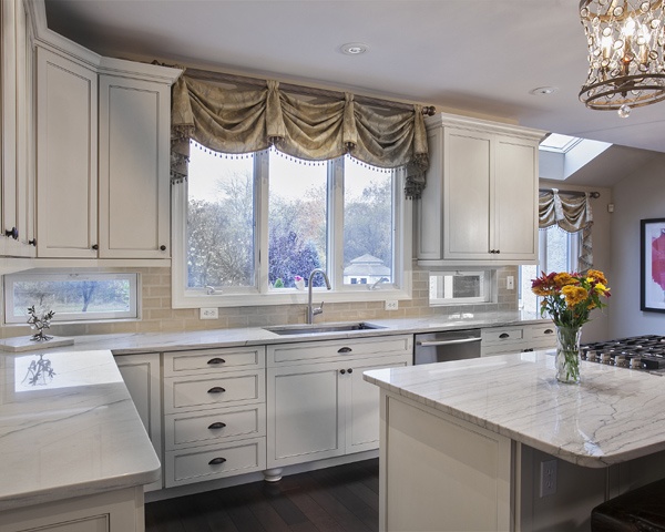 Kitchen with White Cabinets and Backsplash Windows