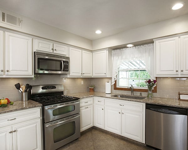 Remodeled Kitchen with Antique White Cabinets and Quartz Countertops