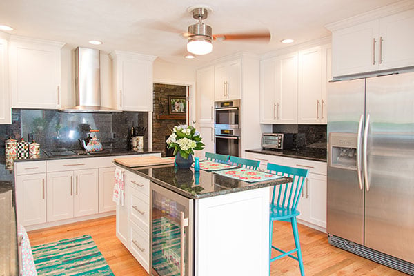 White Cabinet Kitchen with Black Countertop and Backsplash