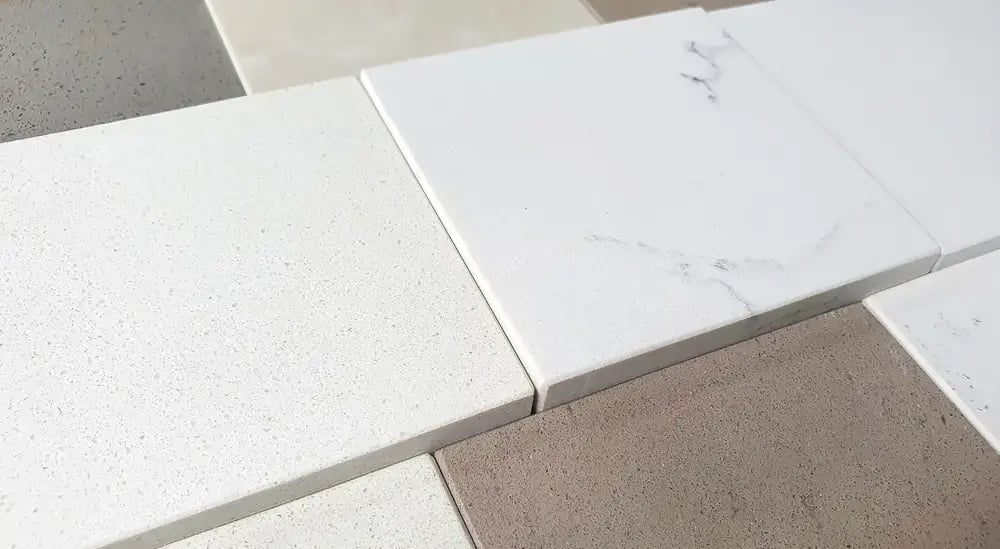 kitchen countertop material samples showing acrylic and artificial stone options