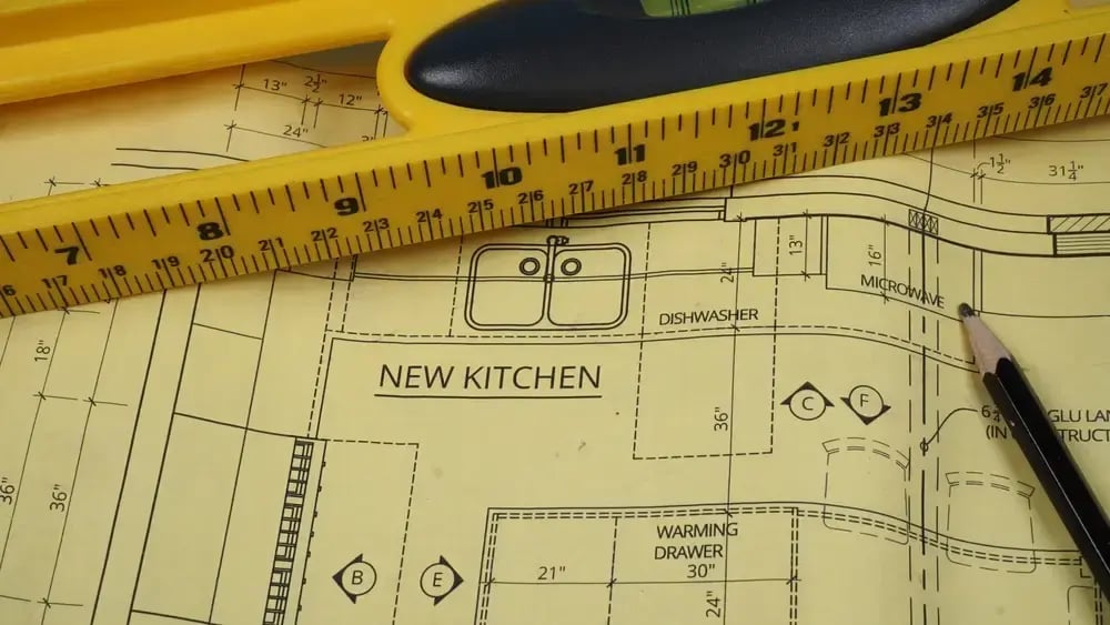 kitchen remodeling blueprints with cabinet and layout plans on a work surface
