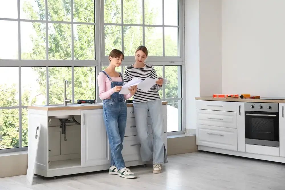 homeowner reviewing furniture assembly instructions during a kitchen update