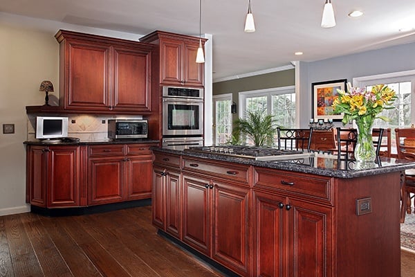 grey wall in kitchen with cherry cabinet